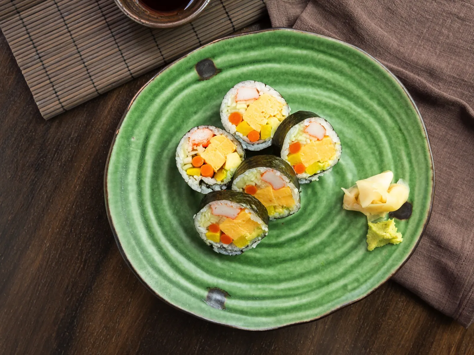 Maki rolls on a green plate at Kikoo Sushi
