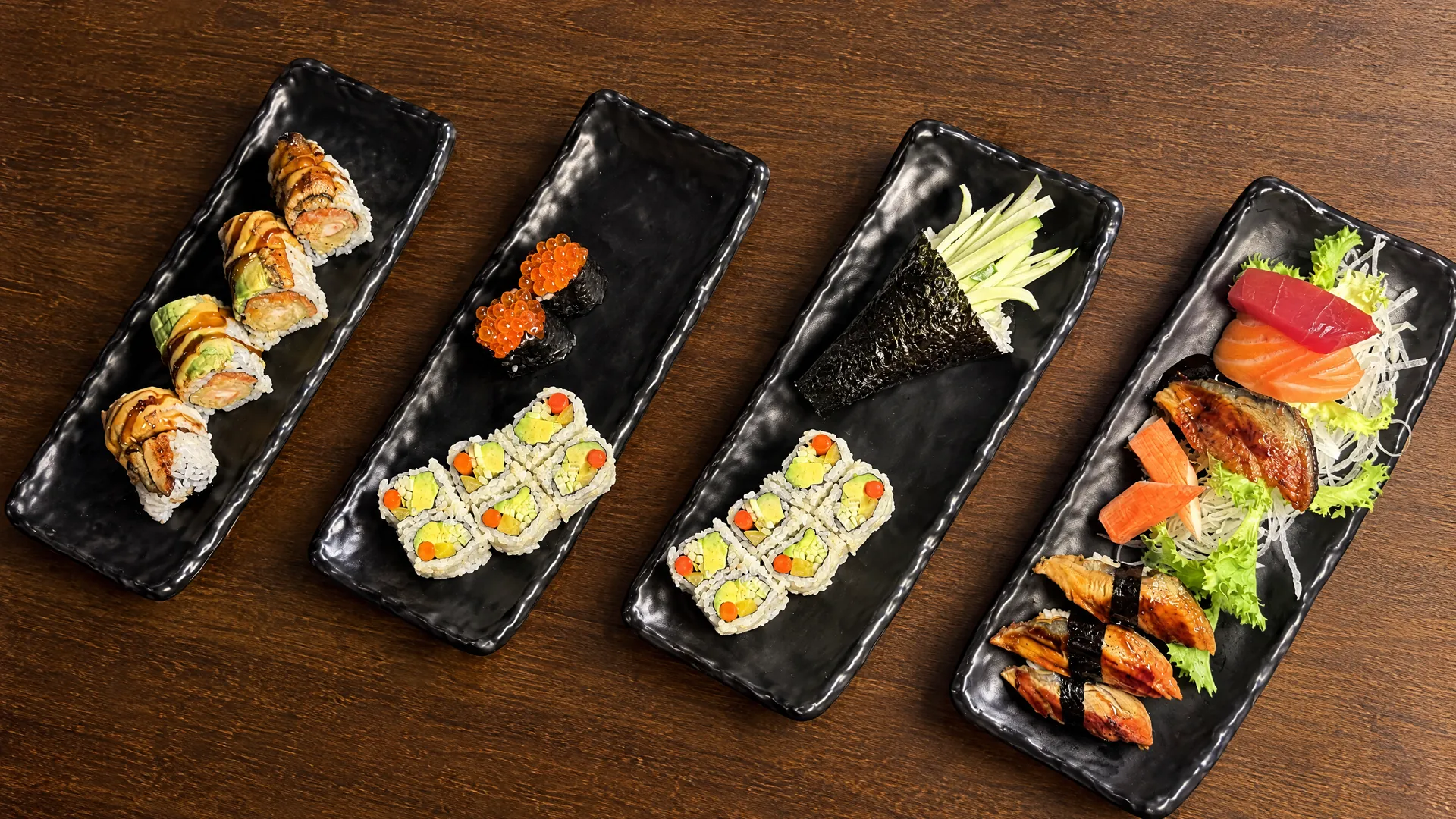 All-you-can-eat sushi spread of four plates at Kikoo Sushi East Village